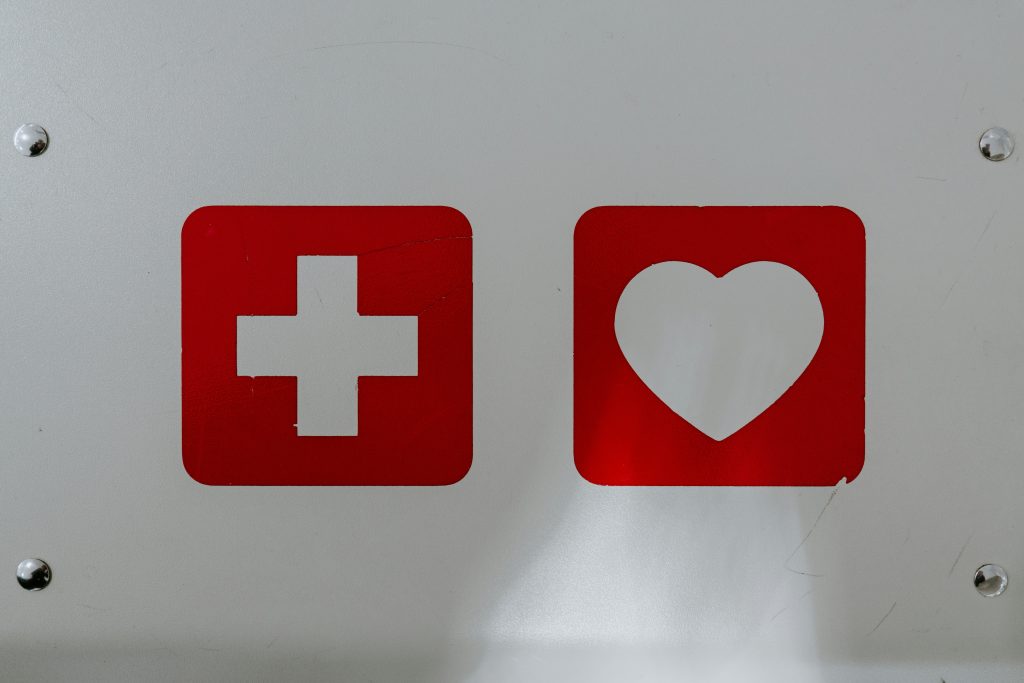 A first aid symbol and a heart symbol
